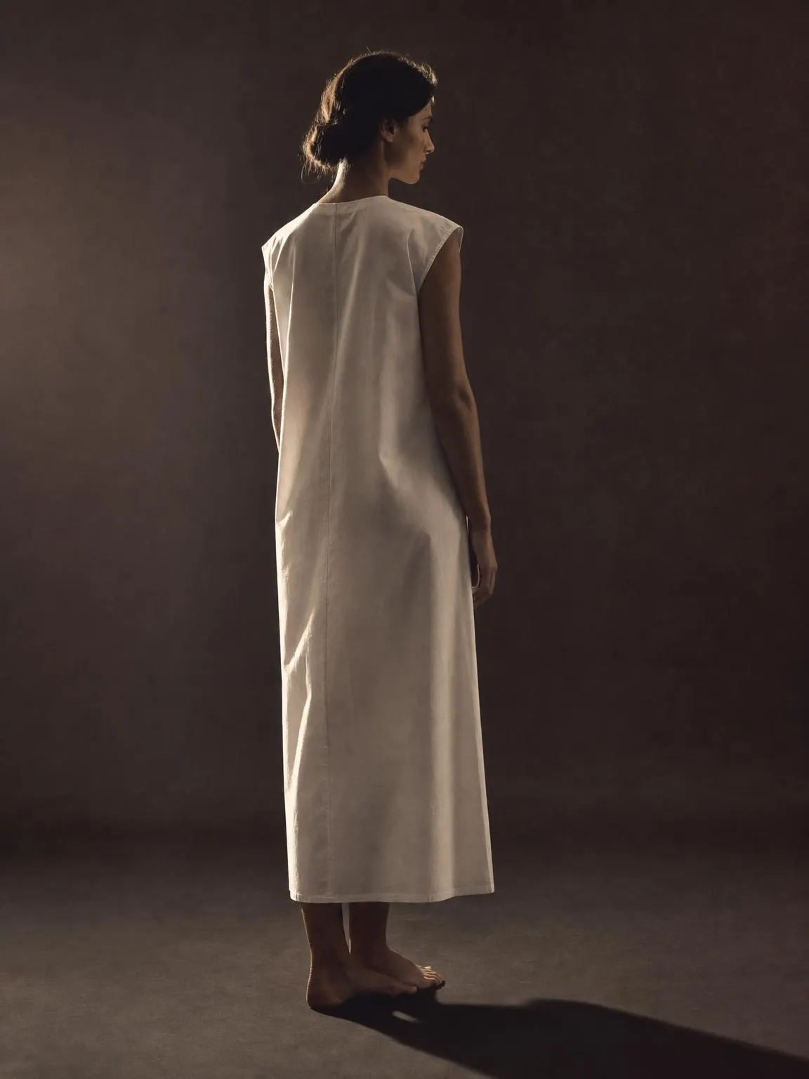 A long column dress in crisp off-white cotton poplin.