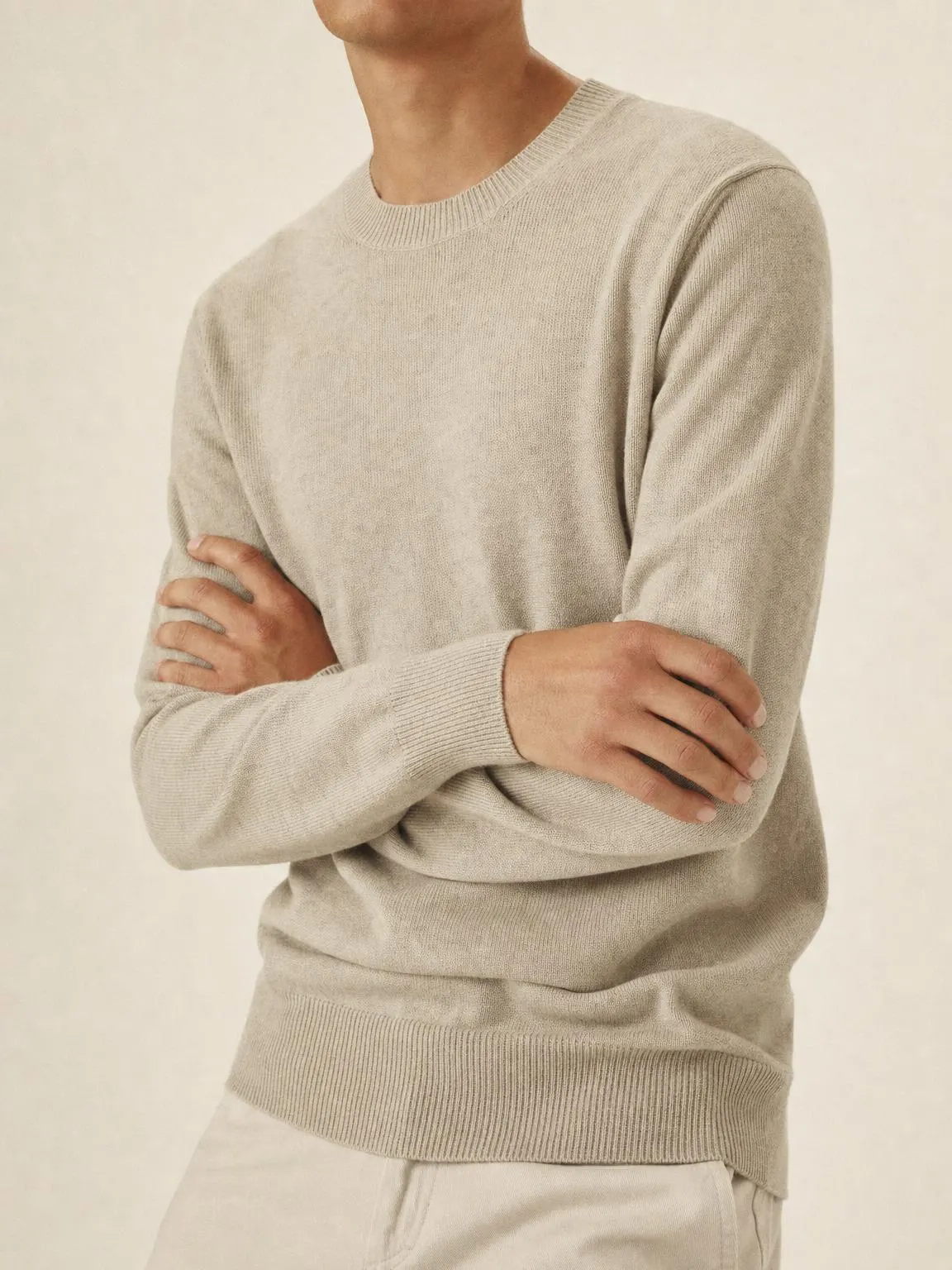 A fine-gauge merino crewneck knit in warm oatmeal.