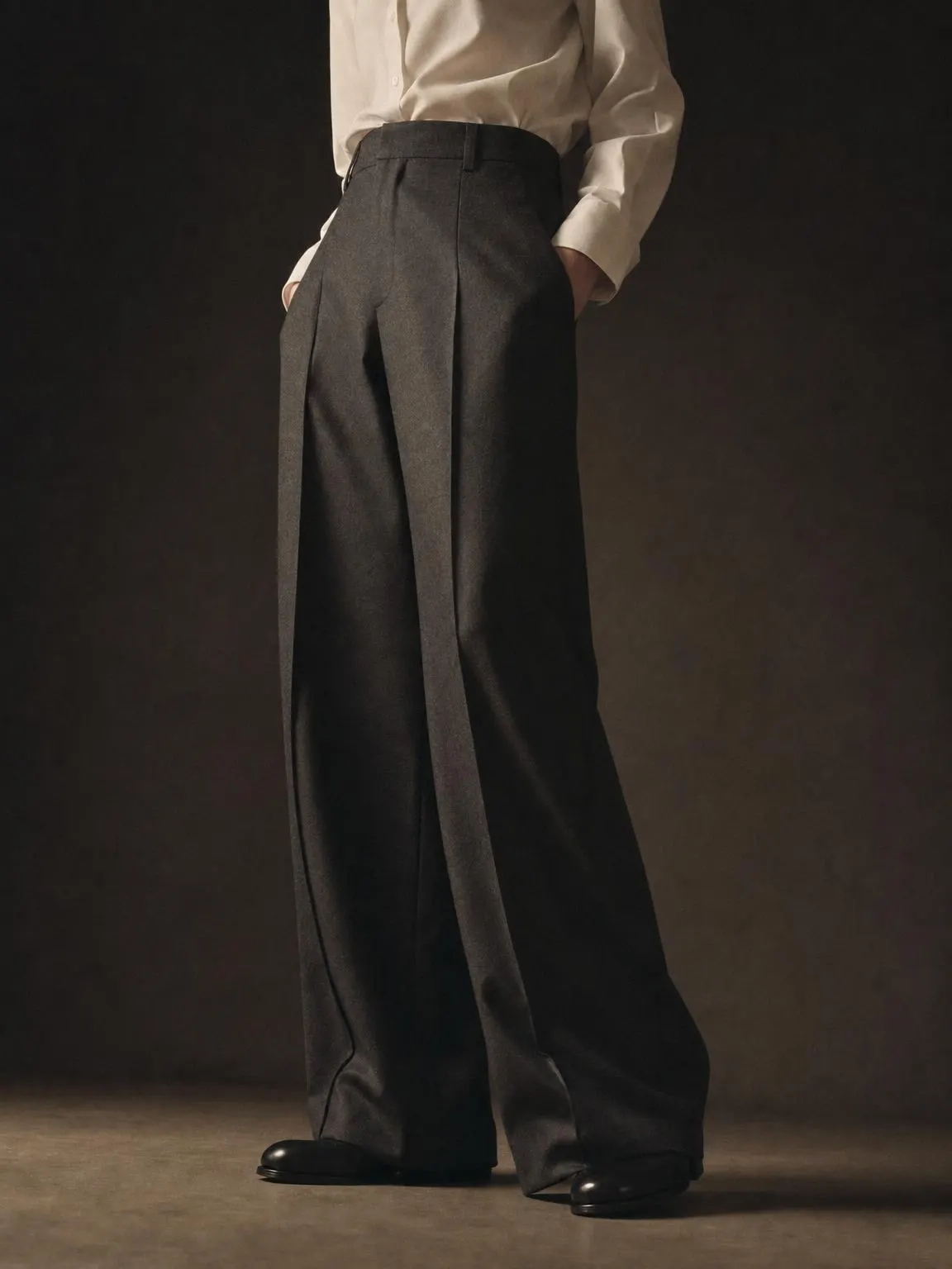 Wide-leg high-waisted wool trousers with a pressed centre crease.